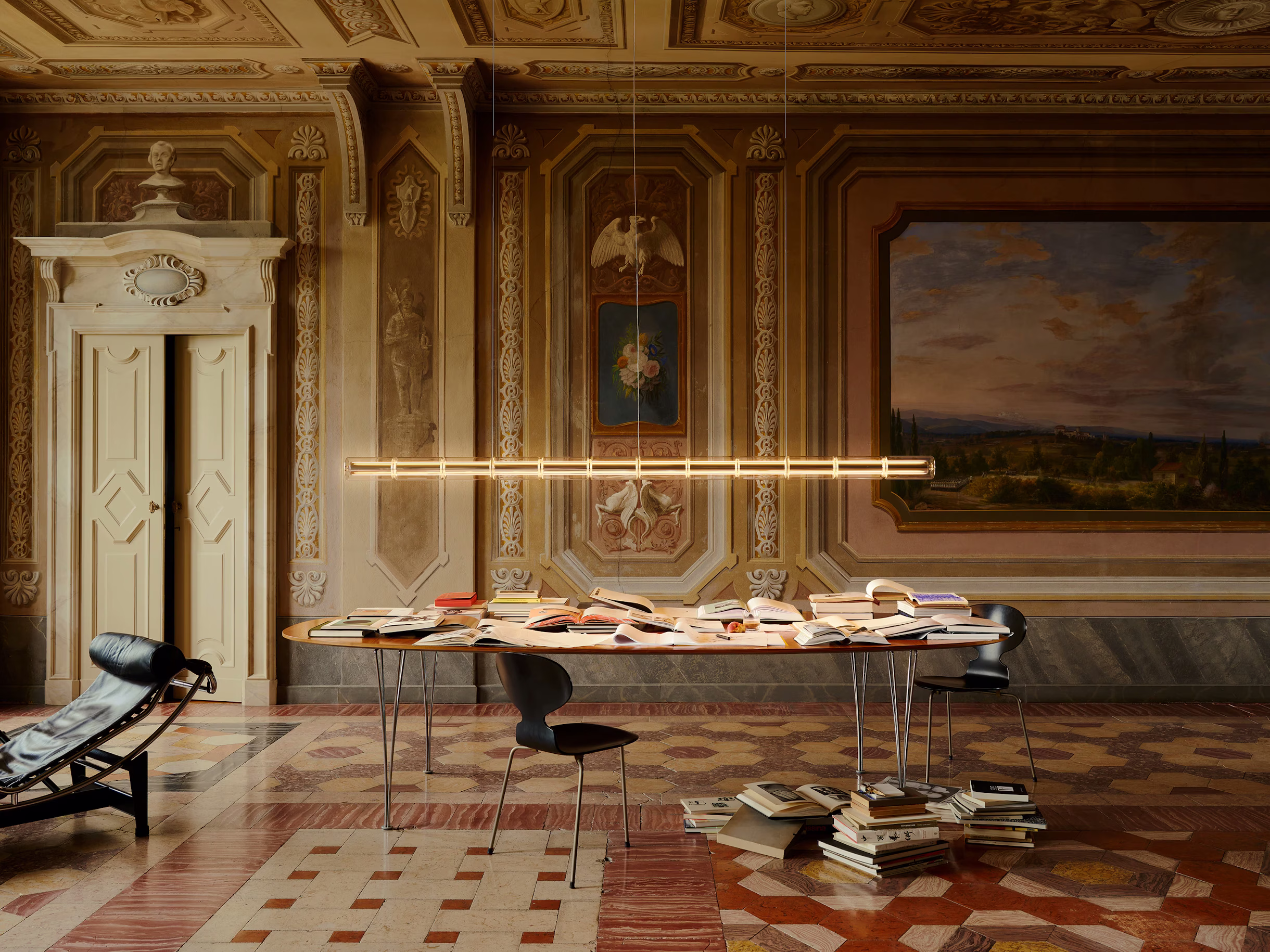 Luce Cilindrica suspended above a minimalist workspace